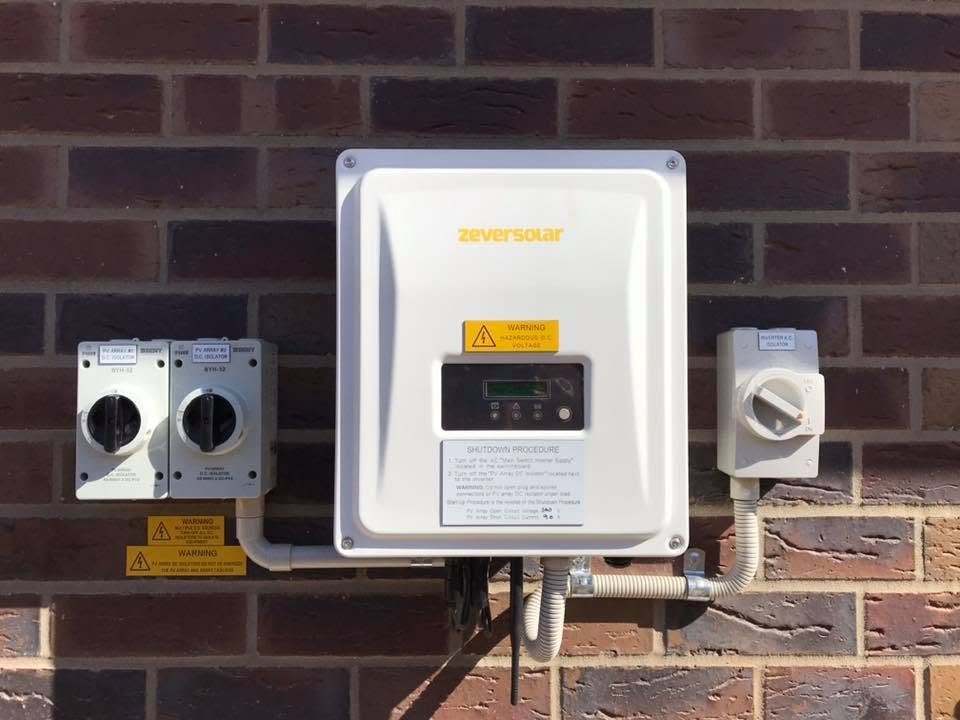 Solar inverter and isolator switches installed on a brick wall