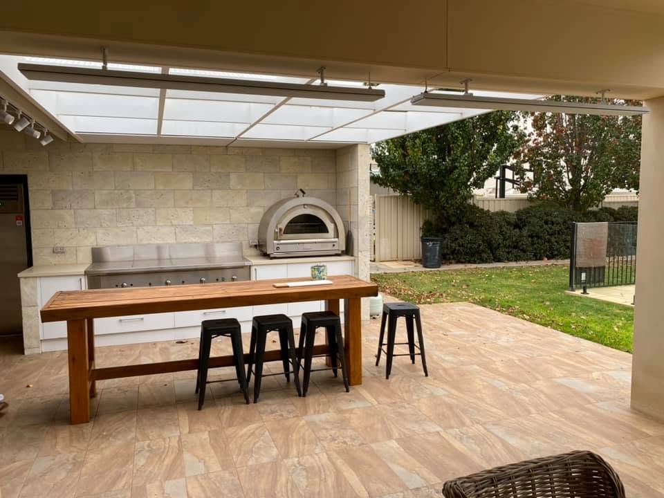 Outdoor alfresco kitchen with pizza oven and overhead heating